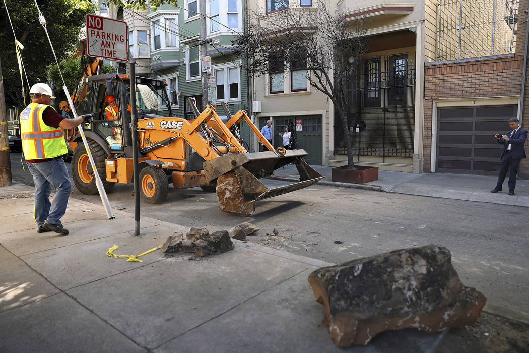 In this Monday, Sept. 30, 2019, photo, a San Francisco Public Works crew removes boulders from ...