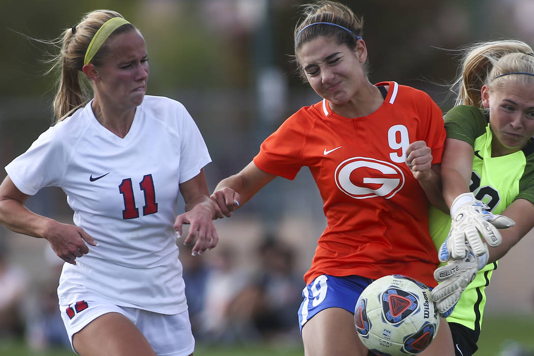 Bishop Gorman's Jaden Terrana (9) fights to maintain control of the ball against Coronado's Tay ...