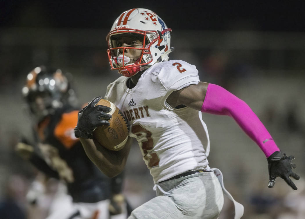 Liberty sophomore wide receiver Germie Bernard (2) breaks down the sideline past a Chaparral de ...