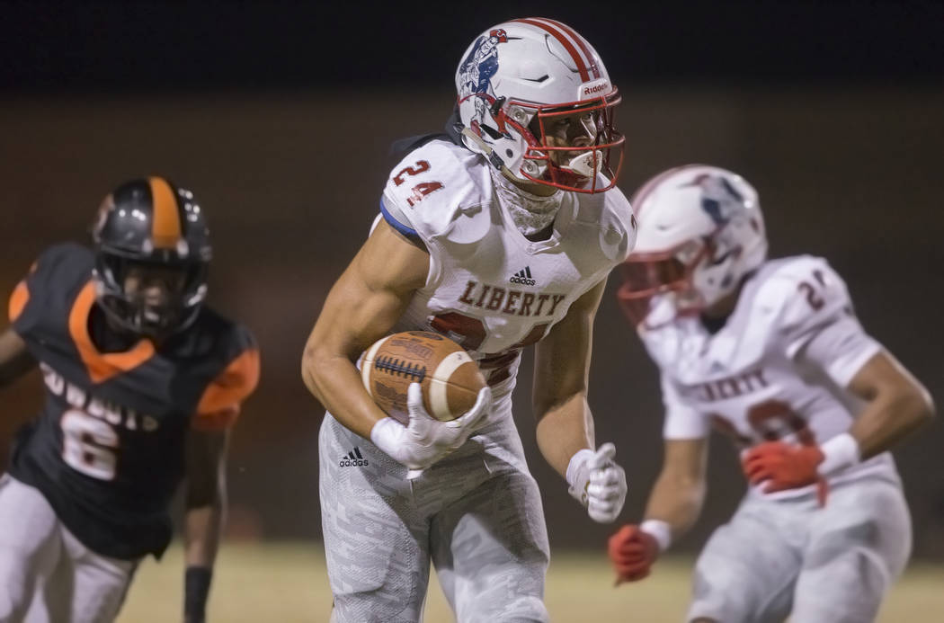 Liberty senior safety Lehi Ausage (24) returns an interception for a touchdown past Chaparral s ...