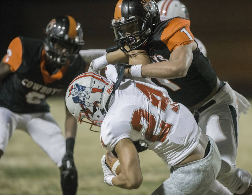 Liberty senior safety Lehi Ausage (1) competes for a ball with Chaparral senior wide receiver L ...