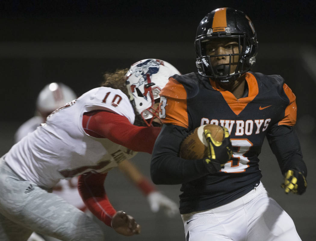 Chaparral senior running back Meshach Hawkins (3) turns the corner past Liberty senior lineback ...