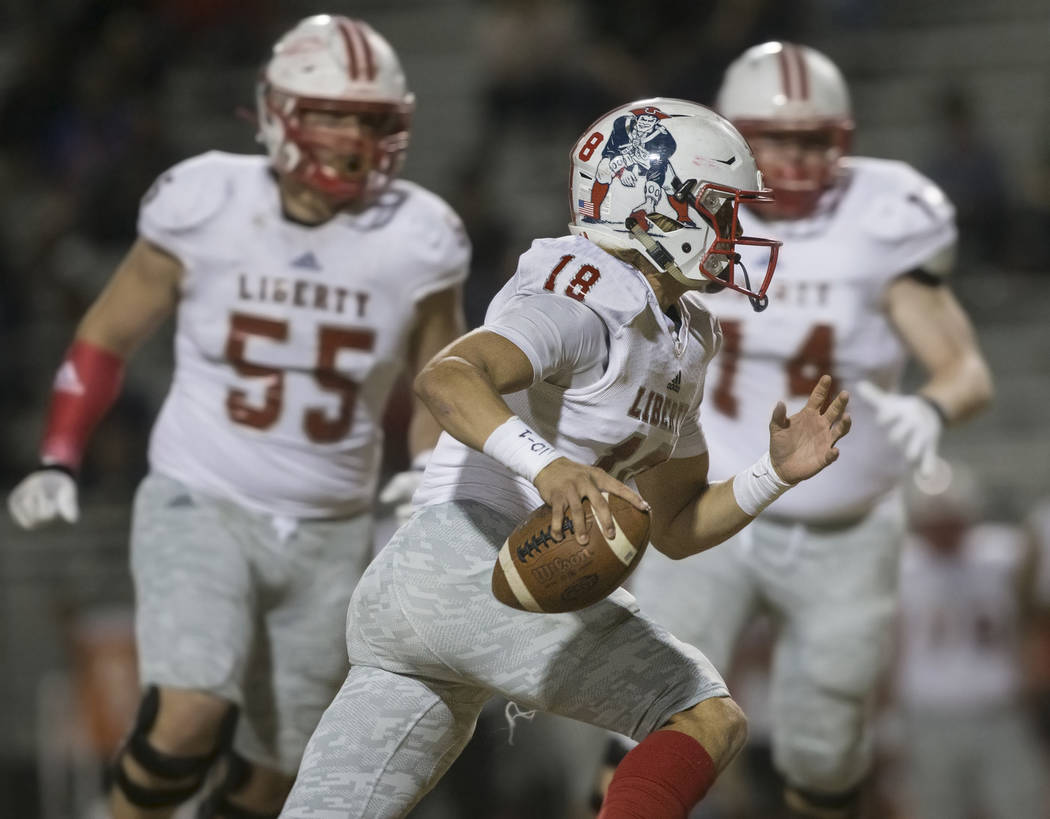 Liberty junior quarterback Daniel Britt (18) scrambles for a big gain in the first quarter duri ...