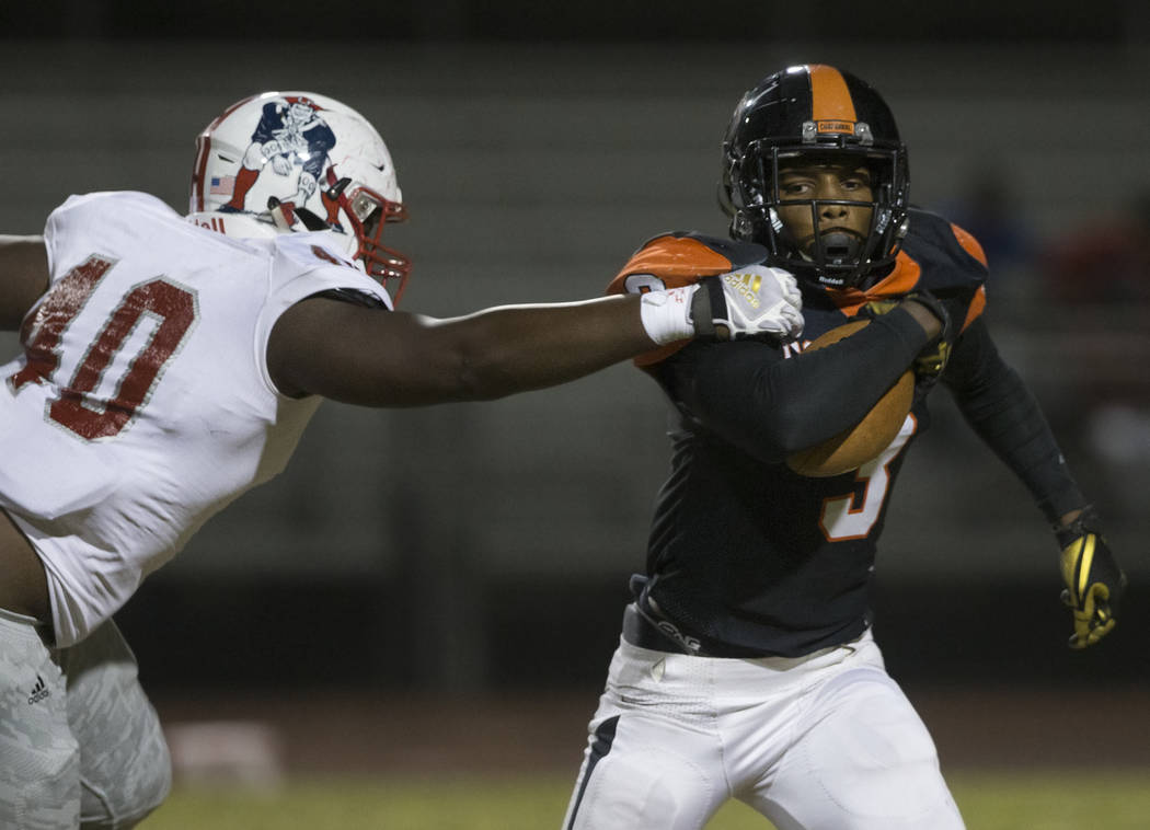 Chaparral senior running back Meshach Hawkins (3) is stopped in the backfield by Liberty sophom ...