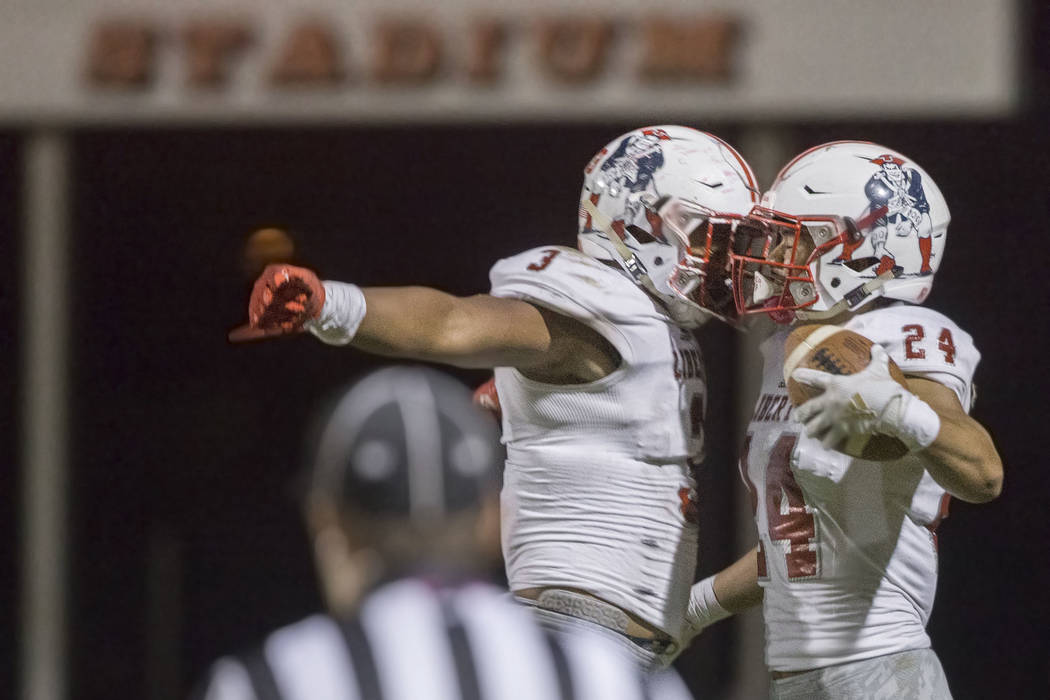 Liberty junior linebacker Zephania Maea (3) and senior safety Lehi Ausage (24) celebrate after ...