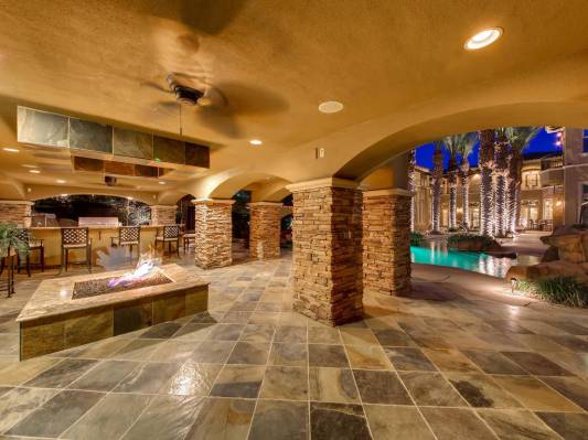 The resort-style backyard features a patio with fire pit. (Virtuance)