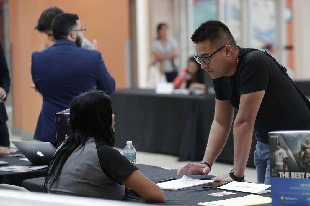 In this Tuesday, Oct. 1, 2019, photo, Gabriel Picon, right, talks with a representative from Ga ...