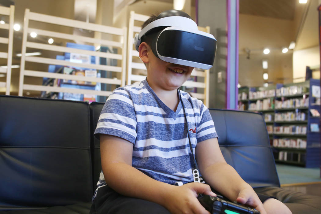 Dominic Giorgi, 10, Henderson, plays a PlayStation 4 VR game in the teen center at Green Valley ...