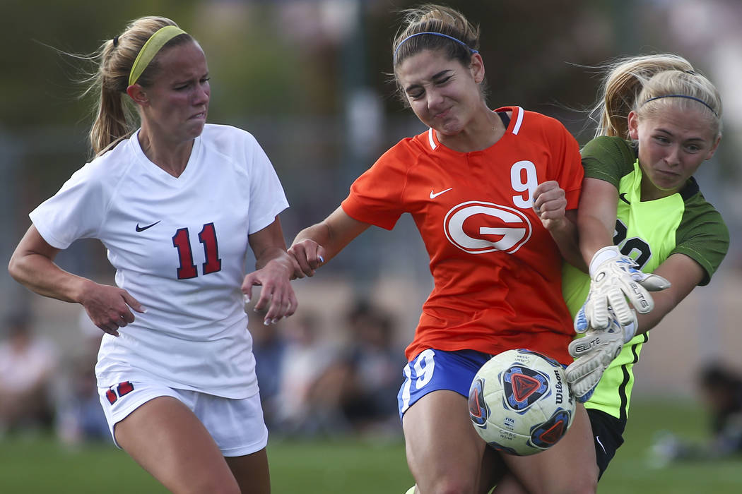 Bishop Gorman's Jaden Terrana (9) fights to maintain control of the ball against Coronado's Tay ...