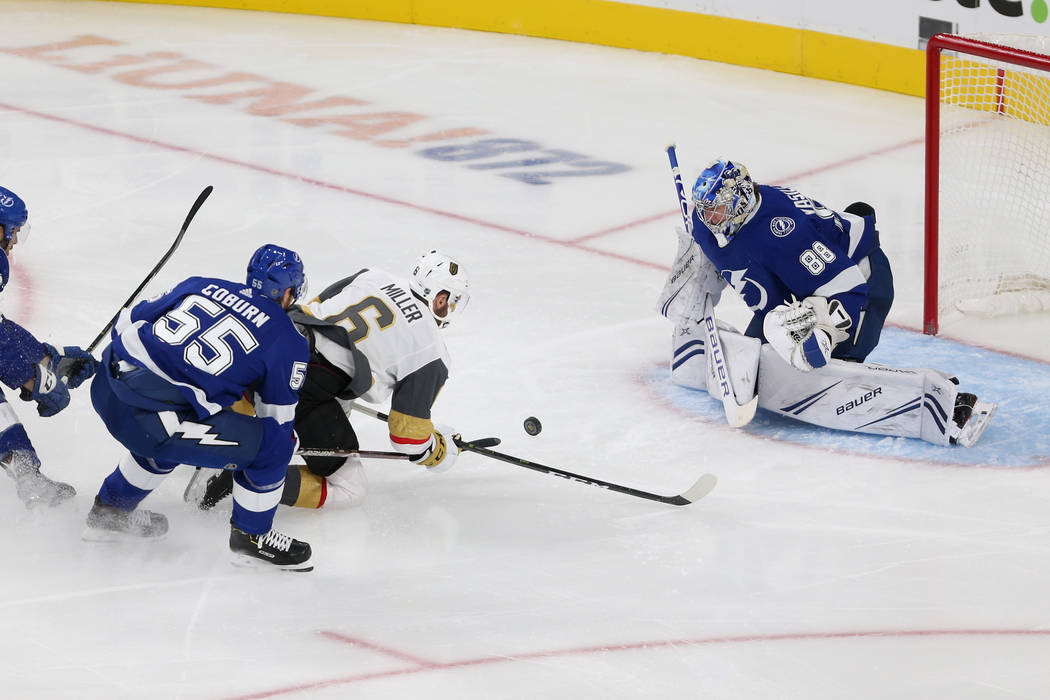 Vegas Golden Knights defenseman Colin Miller (6) is fouled by Tampa Bay Lightning defenseman Br ...