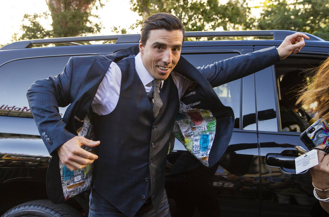 Vegas Golden Knights goaltender Marc-Andre Fleury throws on his suit at arrival to walk the gol ...