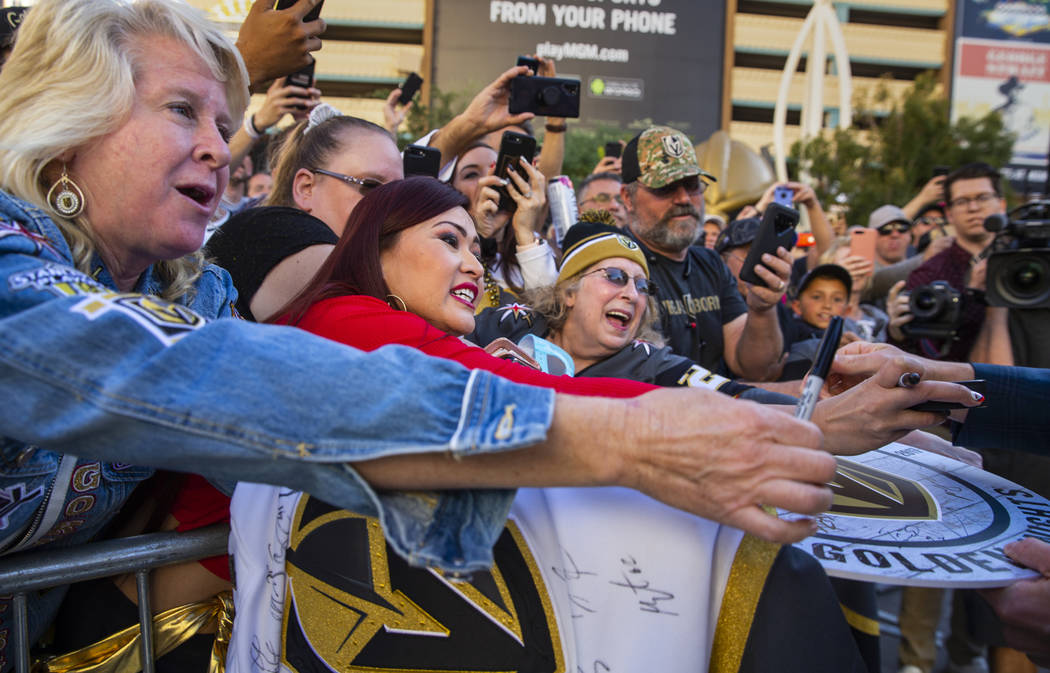 Vegas Golden Knights fans hope for an autograph from goaltender Marc-Andre Fleury, while walkin ...
