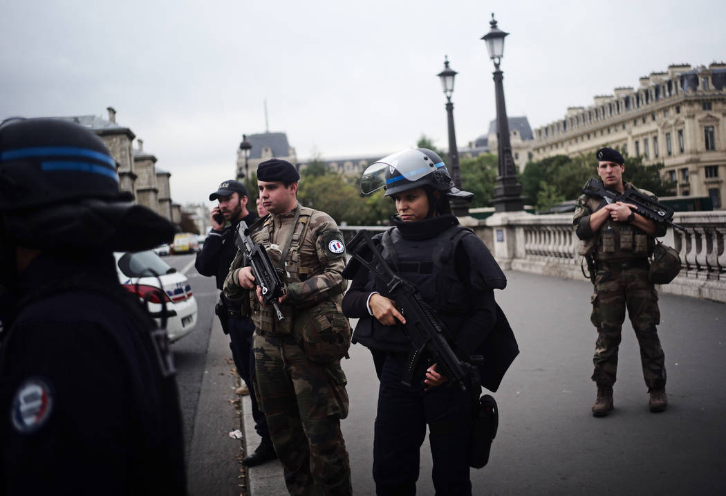 Armed police officers and soldiers patrol after an incident at the police headquarters after in ...