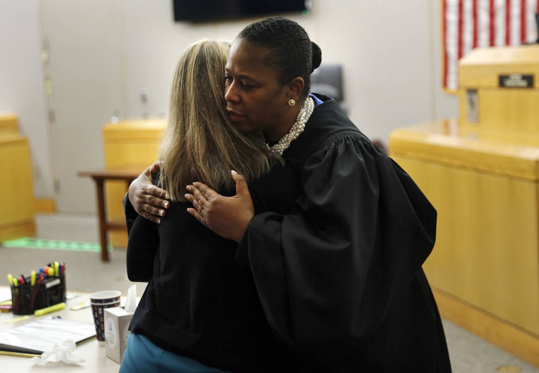 State District Judge Tammy Kemp gives former Dallas Police Officer Amber Guyger a hug before Gu ...