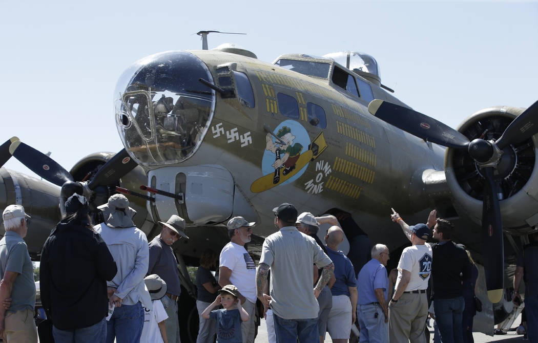 In this photo taken June 2, 2018 photo, people look over the Nine-O-Nine, a Collings Foundation ...