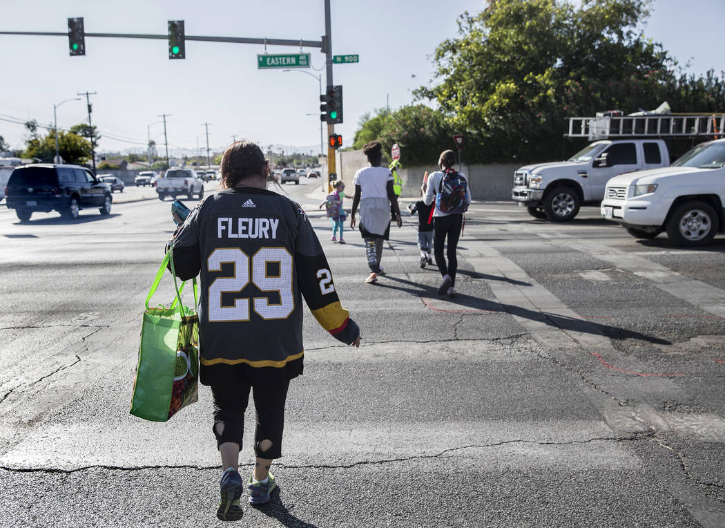 Elena Leger crosses North Eastern Avenue on her way to catch an RTC bus to Toshiba Plaza to wat ...