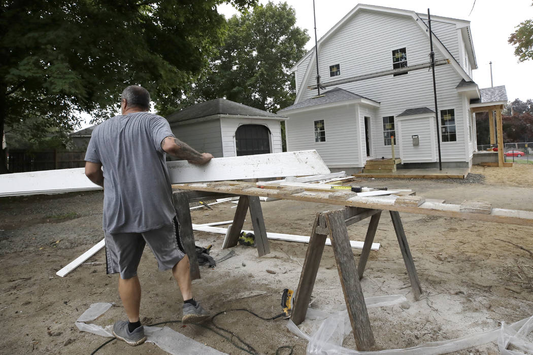 In this Wednesday, Oct. 2, 2019, photo, a carpenter works on a construction site in North Andov ...