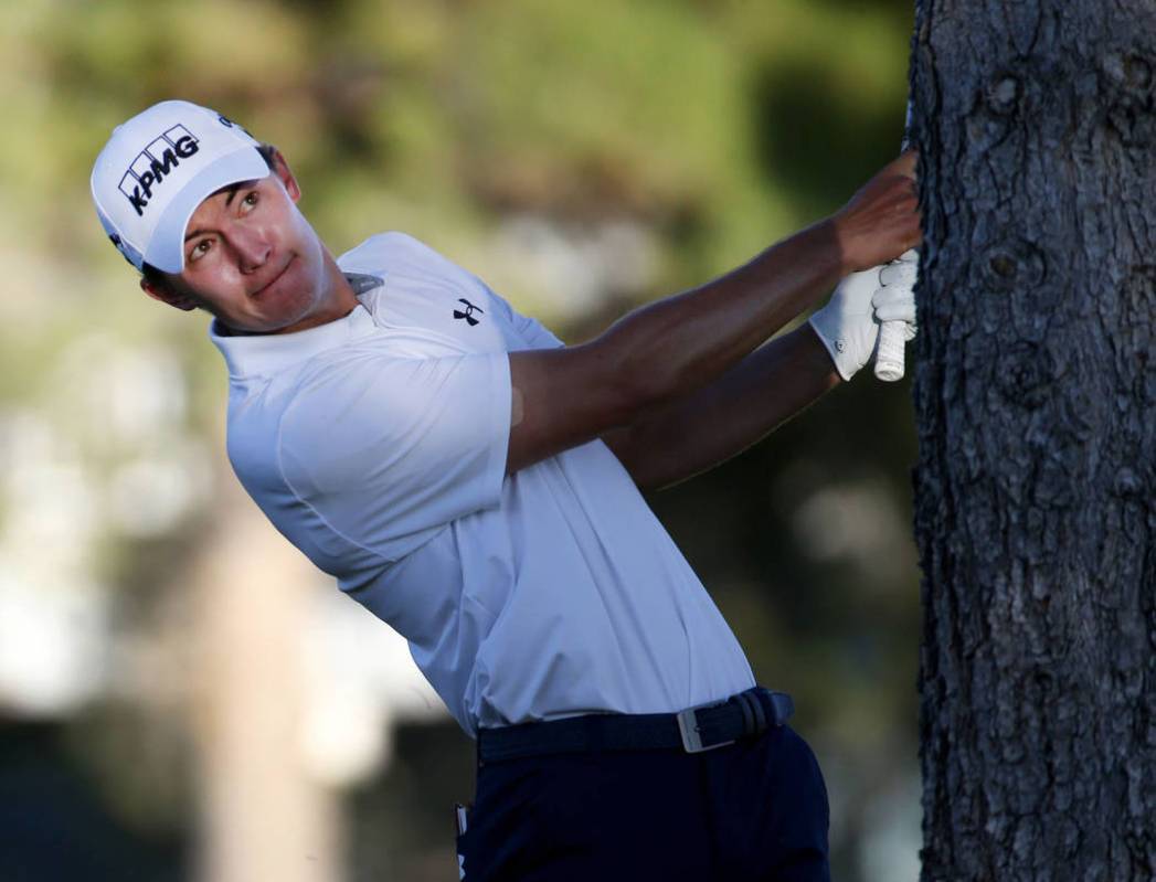 Maverick McNealy of Las Vegas hits from behind a tree on the 16th hole during Shriners Hospital ...