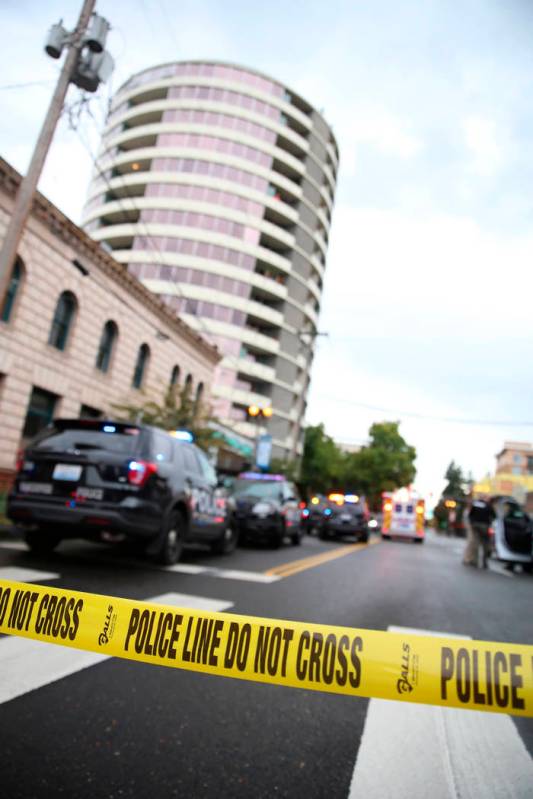 Police respond to a report of gunfire at Smith Tower Apartments in downtown Vancouver, Wash., o ...