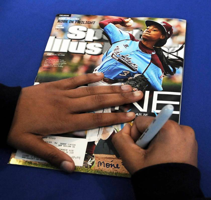 FILE - In this Saturday, Feb. 27, 2016 file photo, Mo'ne Davis, 14, of Philadelphia, signs an a ...