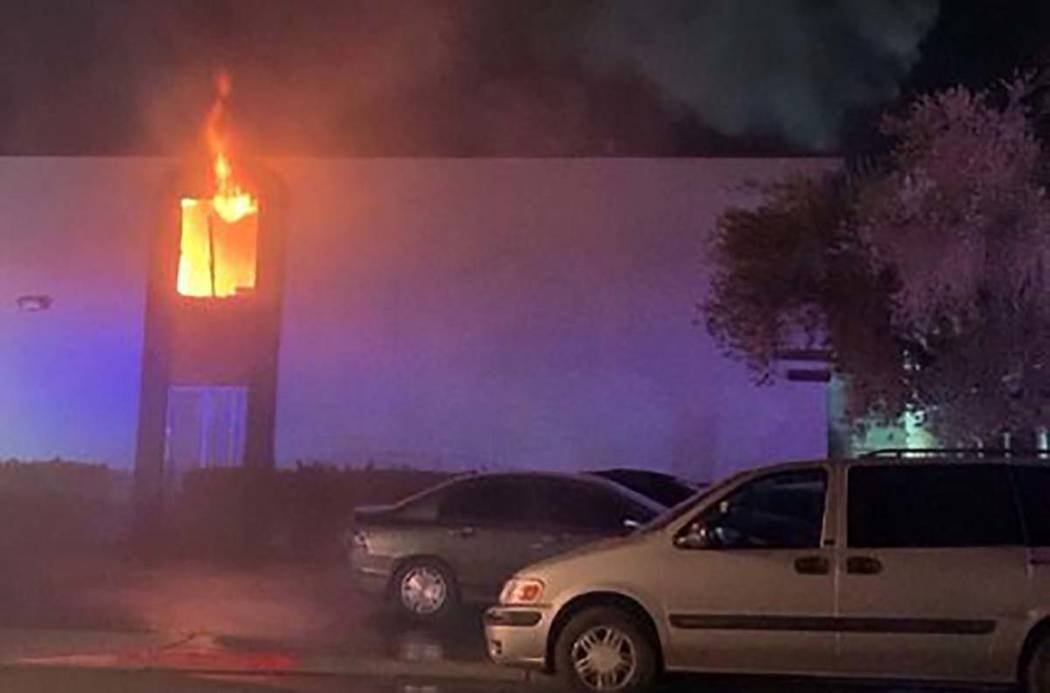 Flames are seen from a second-story apartment at 4264 Silver Dollar Ave. in central Las Vegas e ...