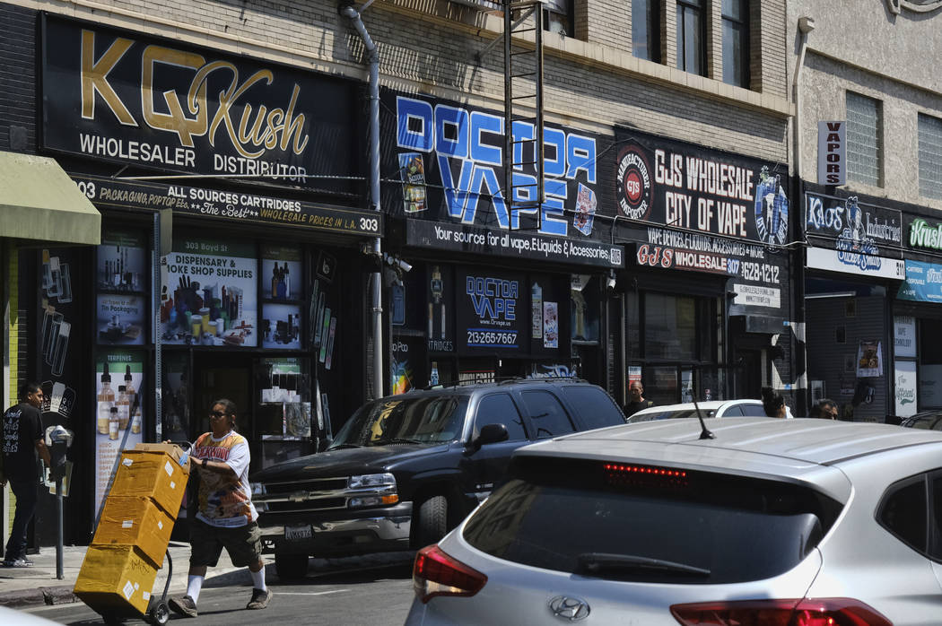 FILE - This Aug. 28, 2019, file photo shows a bustling street lined with wholesale vape shops i ...