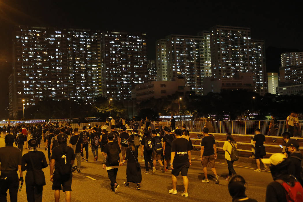 Protesters march on a street in Hong Kong Friday, Oct. 4, 2019. Thousands of defiant masked pro ...