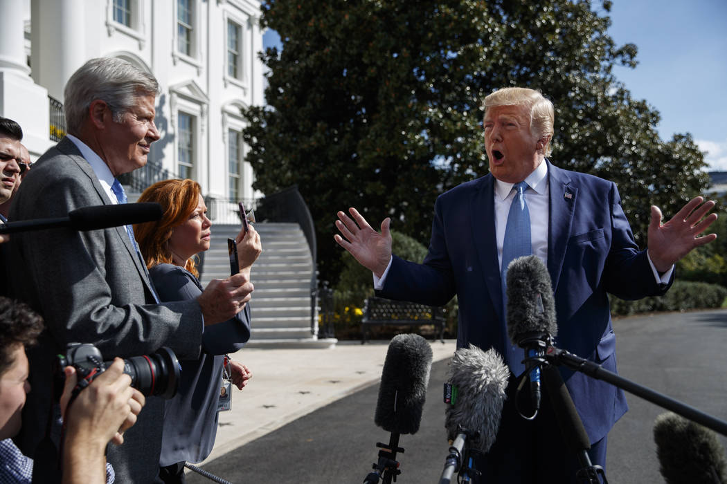 President Donald Trump talks to reporters on the South Lawn of the White House, Friday, Oct. 4, ...