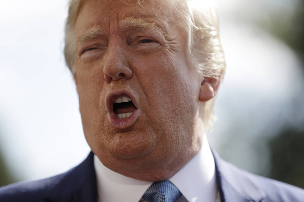 President Donald Trump talks to reporters on the South Lawn of the White House, Friday, Oct. 4, ...