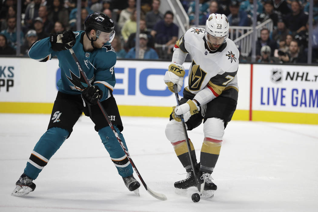 San Jose Sharks' Lean Bergmann, left, moves the puck as Vegas Golden Knights' Brandon Pirri (73 ...