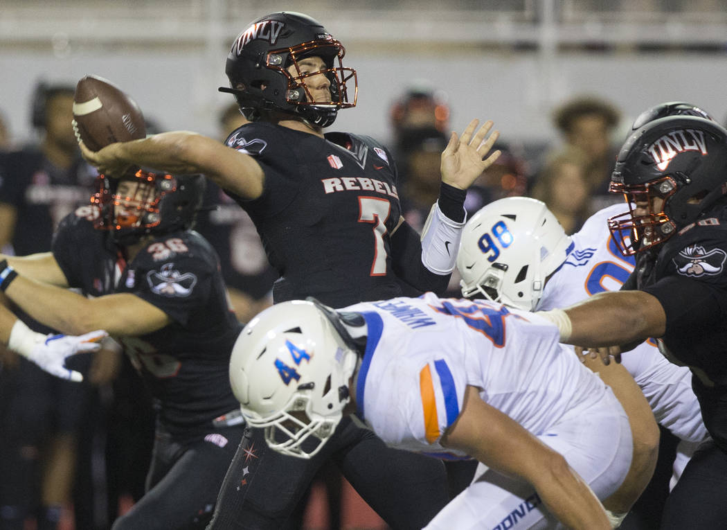 UNLV Rebels quarterback Kenyon Oblad (7) just gets a pass off before the rush from Boise State ...