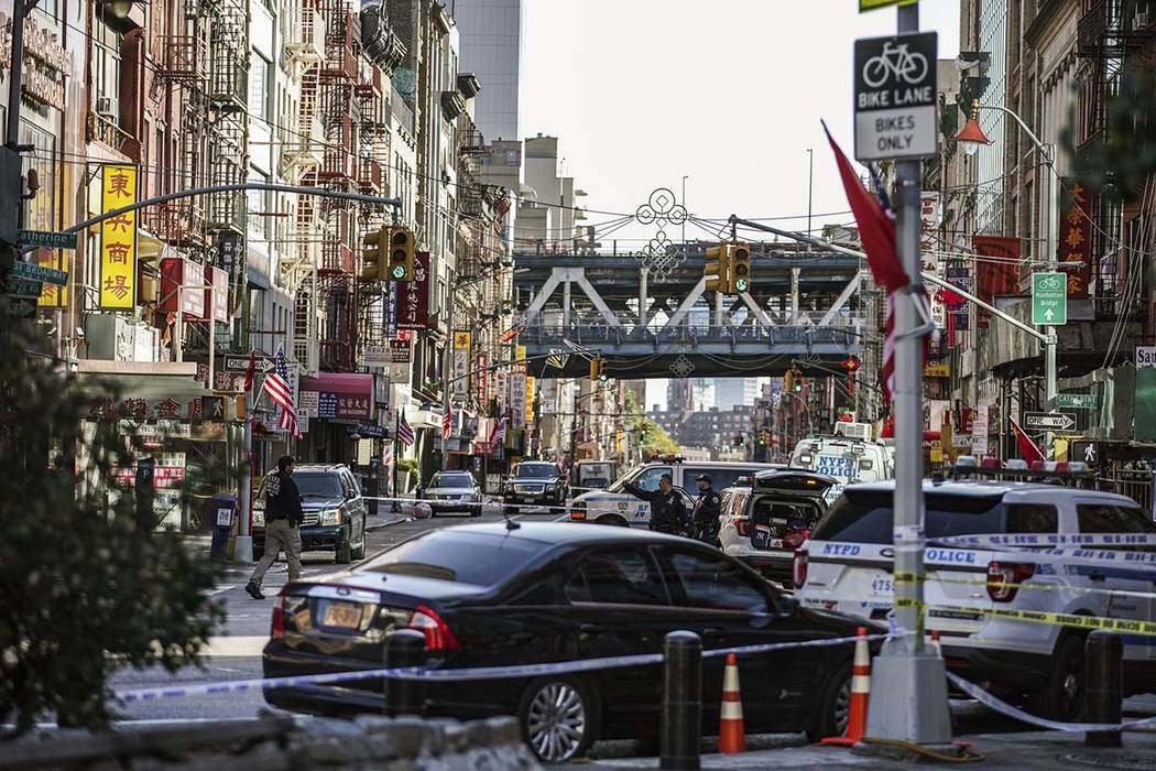 New York Police Department officers investigate the scene of an attack in Manhattan's Chinatown ...