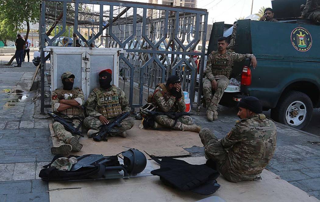 Iraqi riot police deploy near the site of the protests in Tahrir square, central Baghdad, Iraq, ...