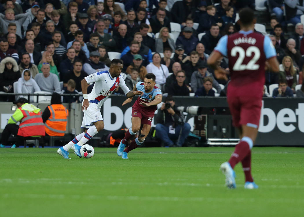 Crystal Palace forward Jordan Ayew (9) moves past West Ham United defender Ryan Fredericks (24) ...