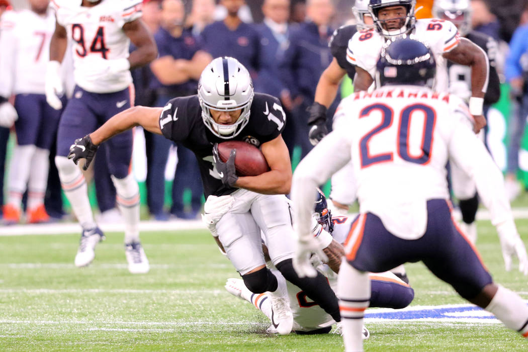 Oakland Raiders wide receiver Trevor Davis (11) tries to break a tackle from Chicago Bears stro ...