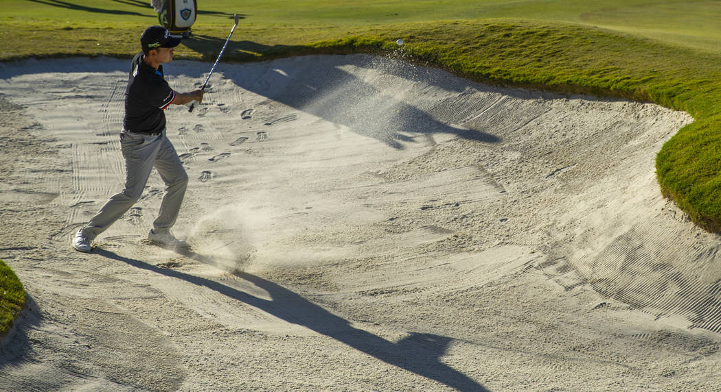 Kevin Na blasts out of the sand onto the green at hole 16 during the final round of Shriners Ho ...