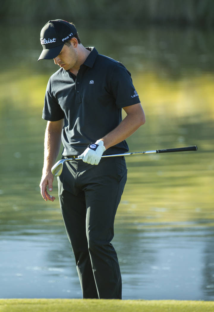 Patrick Cantlay looks down at his club after a bad chip onto the green at hole 17 during the fi ...