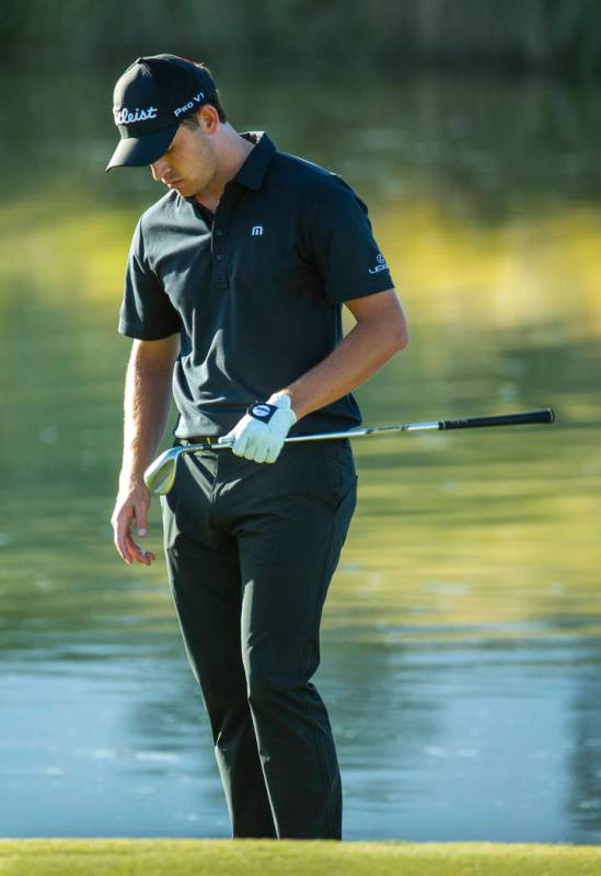 Patrick Cantlay looks down at his club after a bad chip onto the green at hole 17 during the fi ...