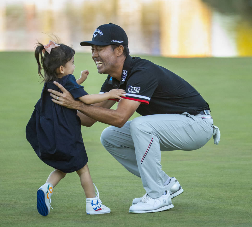 Kevin Na catches his daughter Sophie, 3, who runs to him as he celebrates his victory on the s ...
