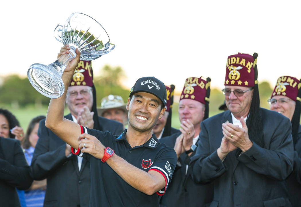 Kevin Na, center, holds up his trophy after winning the tournament at the final round of Shrine ...