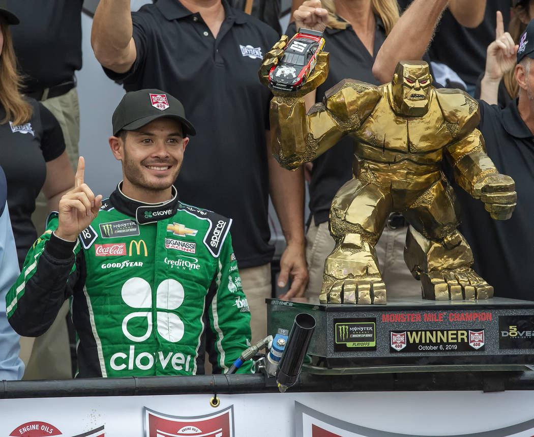 Kyle Larson stands next to the trophy after winning the NASCAR Cup Series auto race Sunday, Oct ...