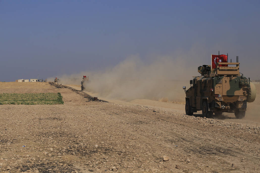 A Turkish n armored vehicles patrol as they conduct a joint ground patrol with American forces ...