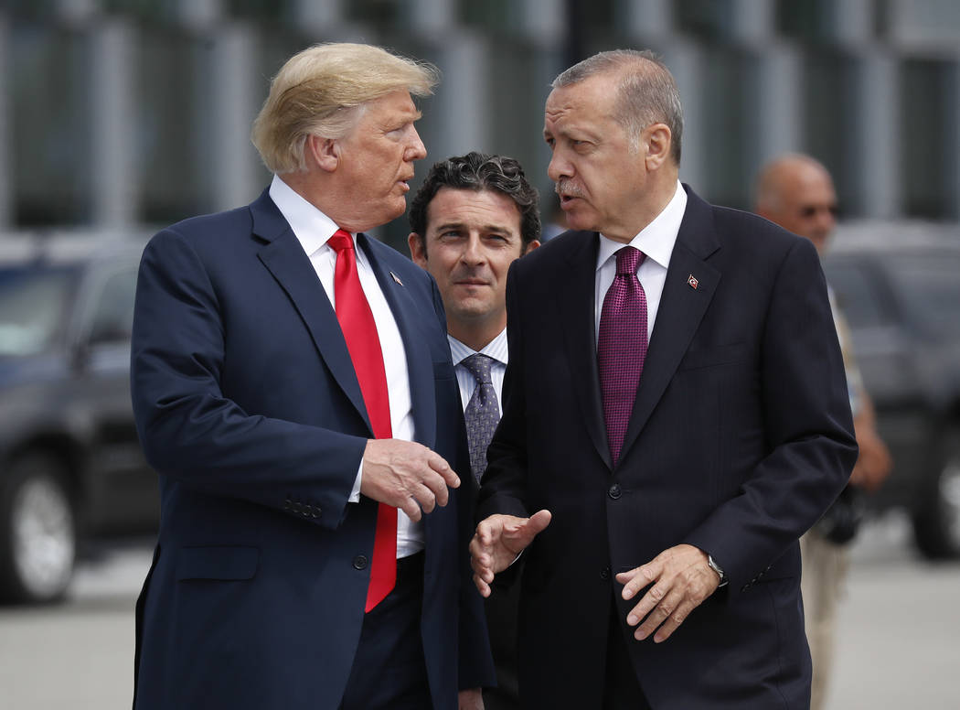 FILE - In this Wednesday, July 11, 2018, file photo, President Donald Trump, left, talks with T ...