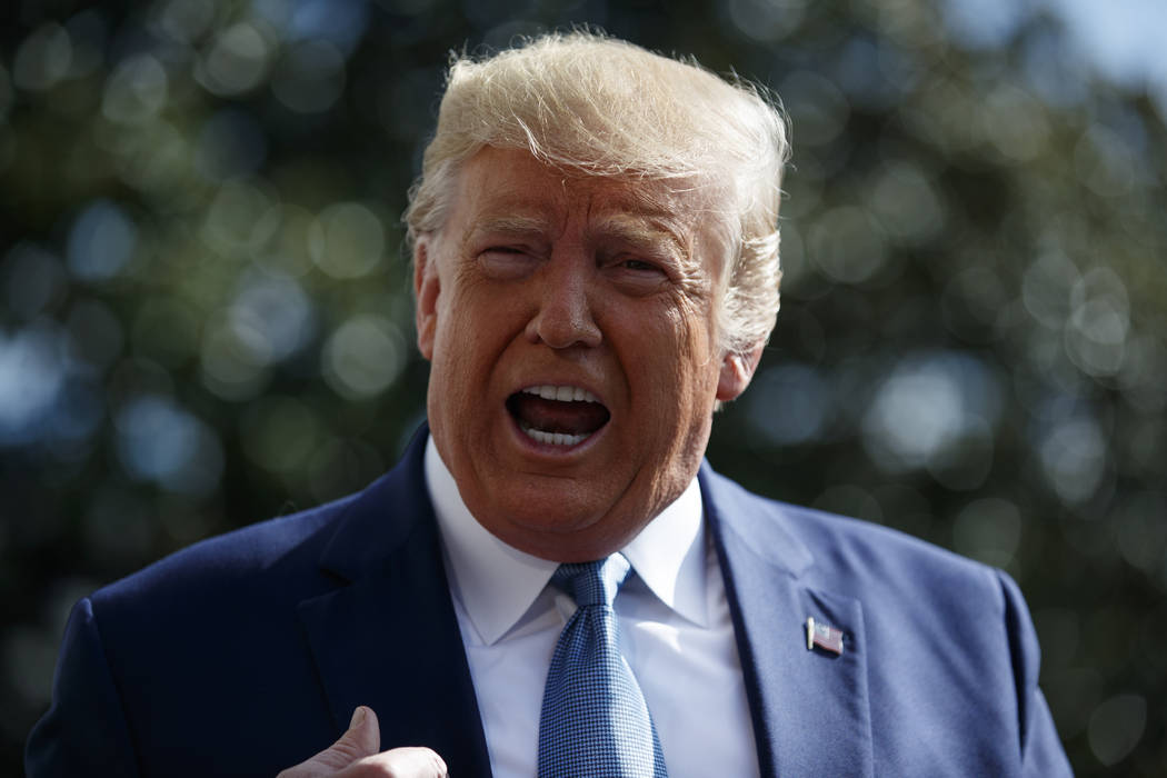 President Donald Trump talks to reporters on the South Lawn of the White House, Friday, Oct. 4, ...