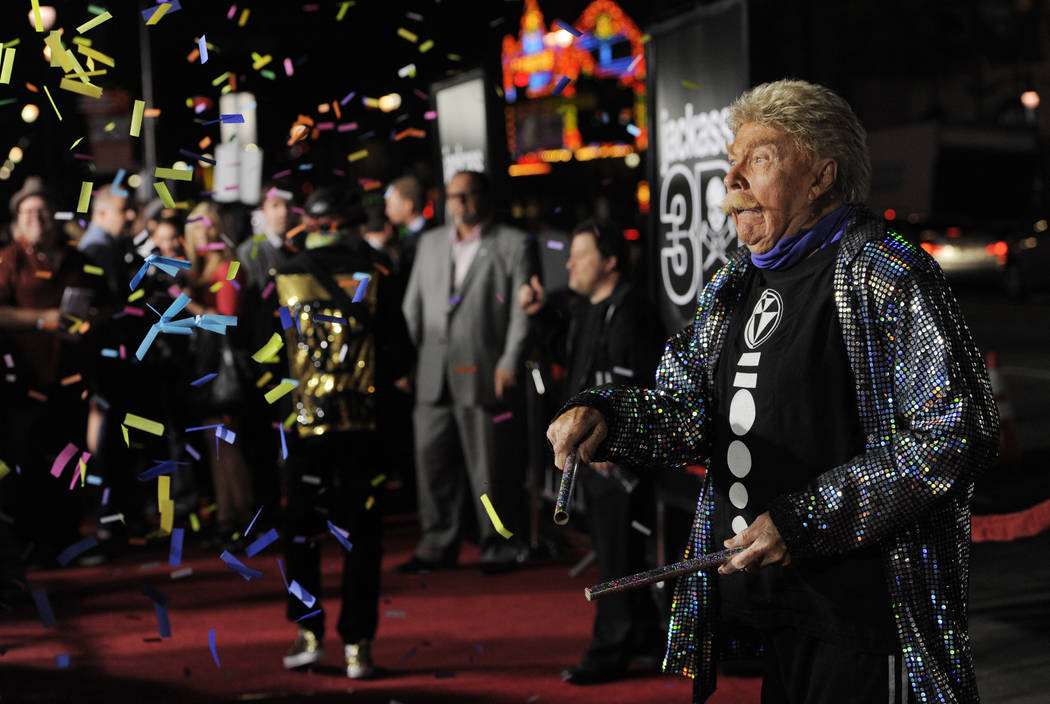Comedian Rip Taylor throws confetti on photographers at the premiere of the film "Jackass ...