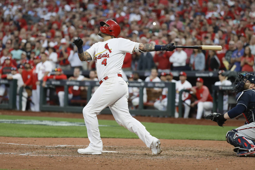 St. Louis Cardinals' Yadier Molina hits a sacrifice fly to score Kolten Wong for the winning ru ...