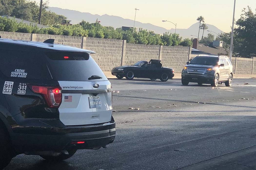 Las Vegas police investigate an injury crash at Harmon Avenue and Sandhill Road in east Las ...