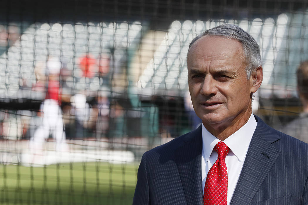 Commissioner Rob Manfred watches as the American League players warm-up for the MLB baseball Al ...