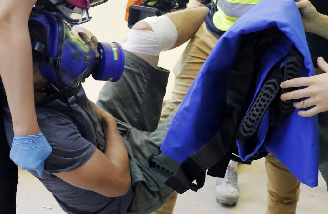 In a Sept. 15, 2019, file photo, an injured man is carried away during protests in Hong Kong. W ...