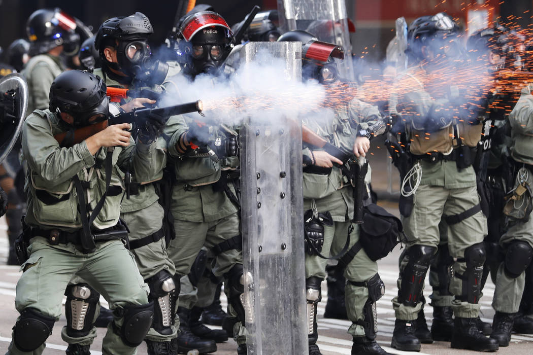 FILE - In this Oct. 1, 2019, file photo, police fire tear gas to disperse anti-government prote ...